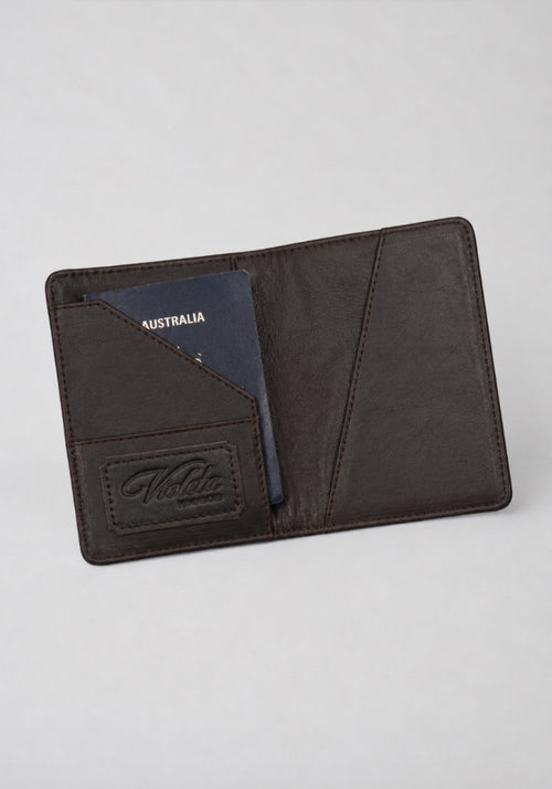 Amaretto passport case open with an Australian passport inside and the embossed Violeta logo