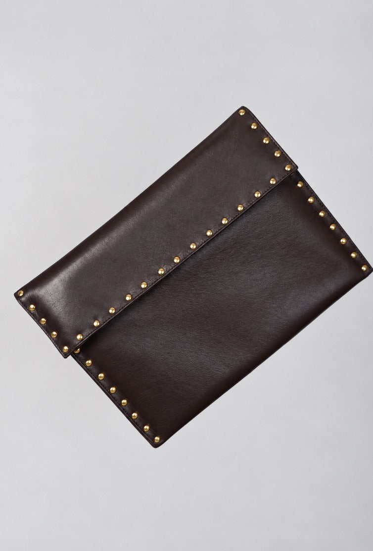 Dark brown leather Amaretto laptop case by Violeta with gold stud trim, front view showing the flap