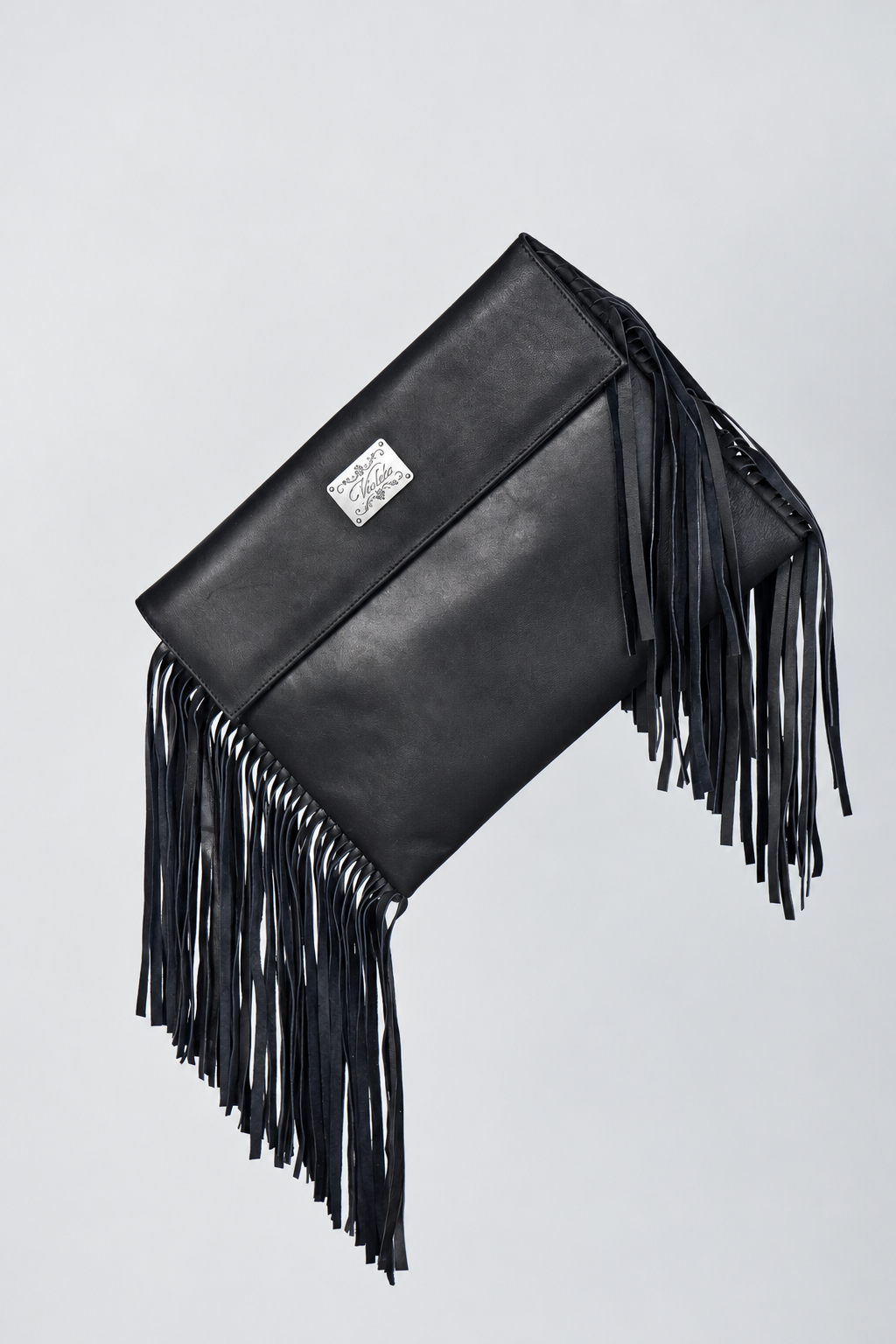 Black leather Shalom Fringe laptop case by Violeta with long leather fringe and an engraved silver plate on the flap, front view