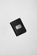 Black leather Shalom passport case by Violeta with an engraved silver plate on the front, front view